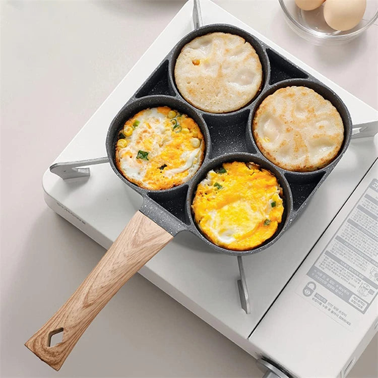 Eway egg and pancake skillet with four burners, non-stick surface, suitable for breakfast cooking, shown with cooking utensils.