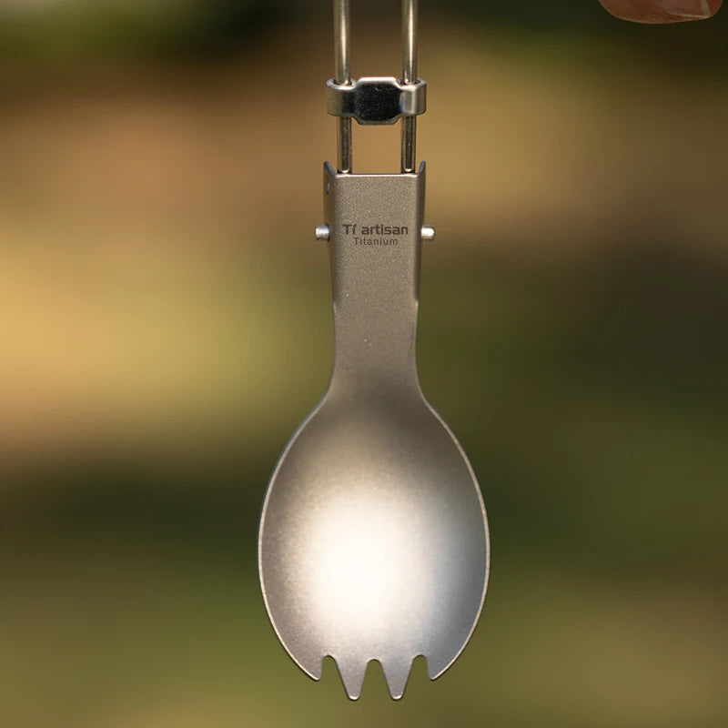 Eway Tiartisan titanium dining utensils set with fork, knife, and spoon arranged on a wooden surface.