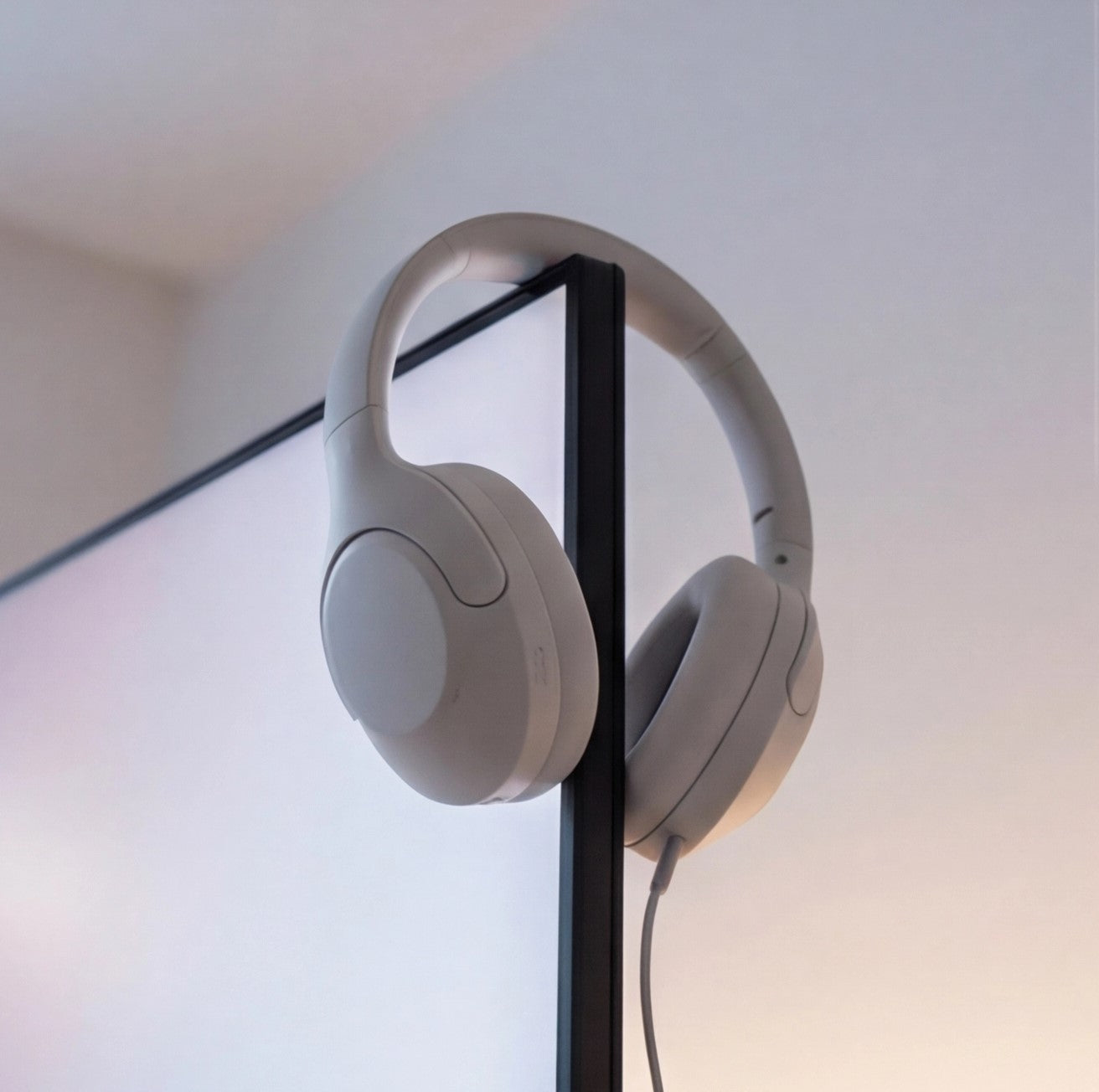 Eway QCWY earphones with black wireless earbuds and inline microphone, close-up view of the compact design.